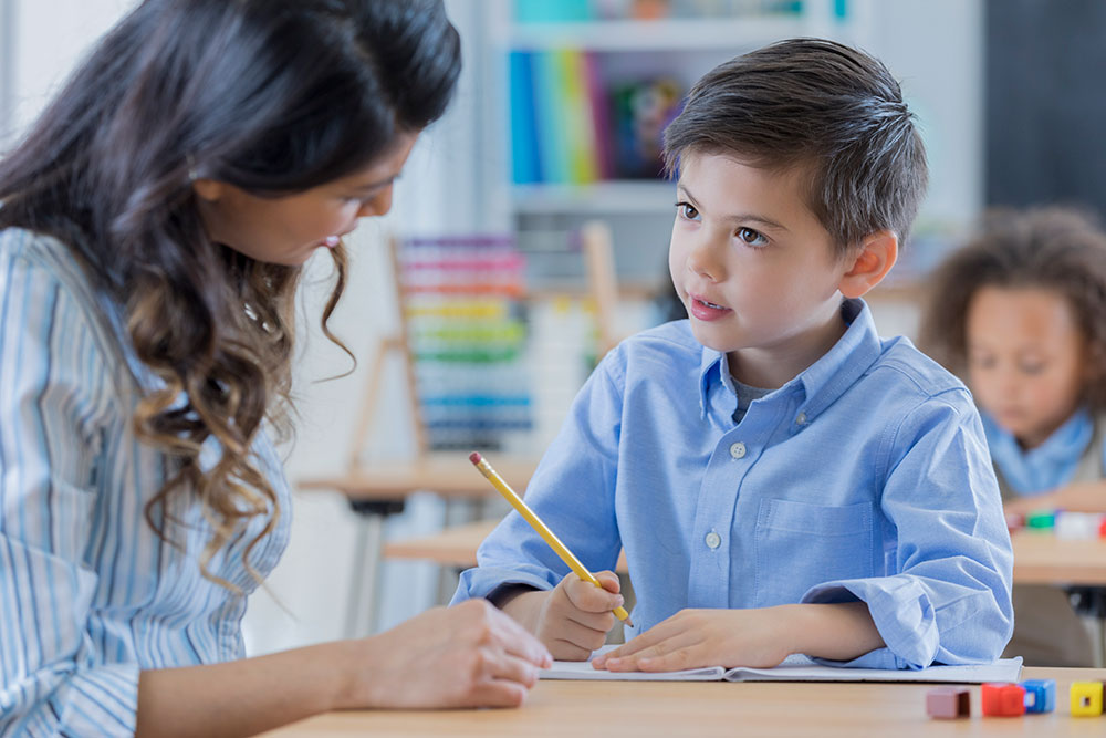 Teacher working together with a student.